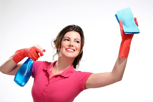 Dusting and vacuuming in a tidy bedroom